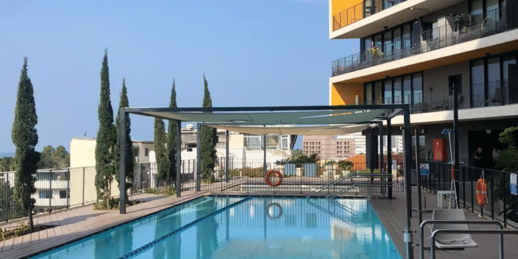 Outdoor pool area with modern shading at Elifelet project Tel Aviv