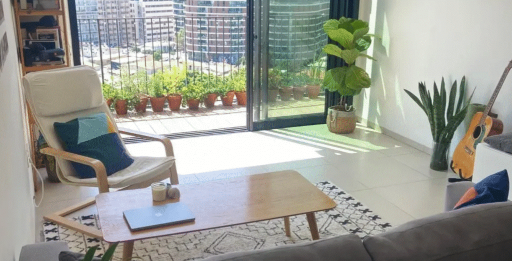 Bright living room with balcony access and city view in Tel Aviv apartment