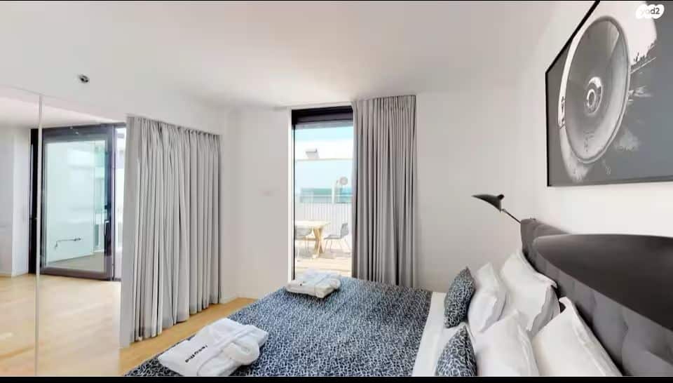 Bright modern bedroom with access to private terrace and sea views