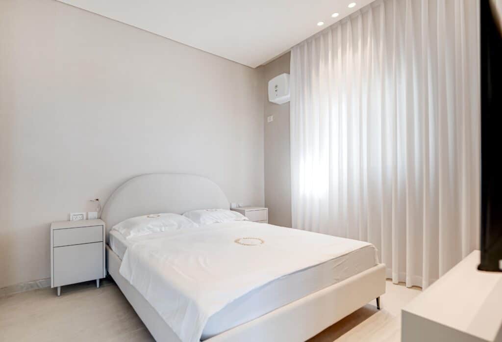 Minimalist bedroom with natural light in Tel Aviv rental apartment