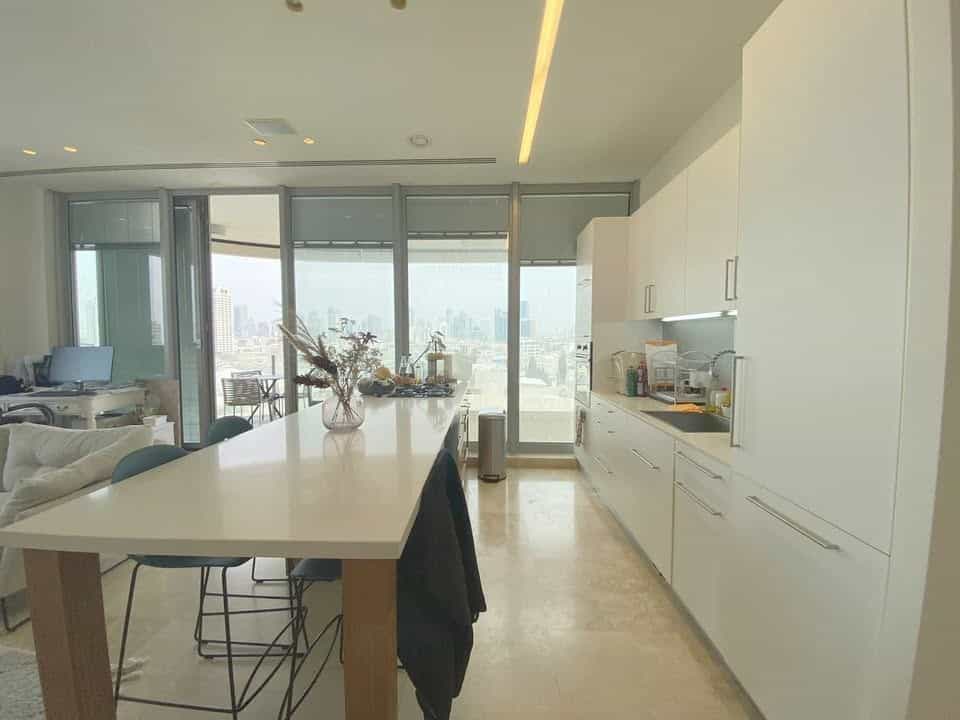 Modern open kitchen with island and Tel Aviv skyline views