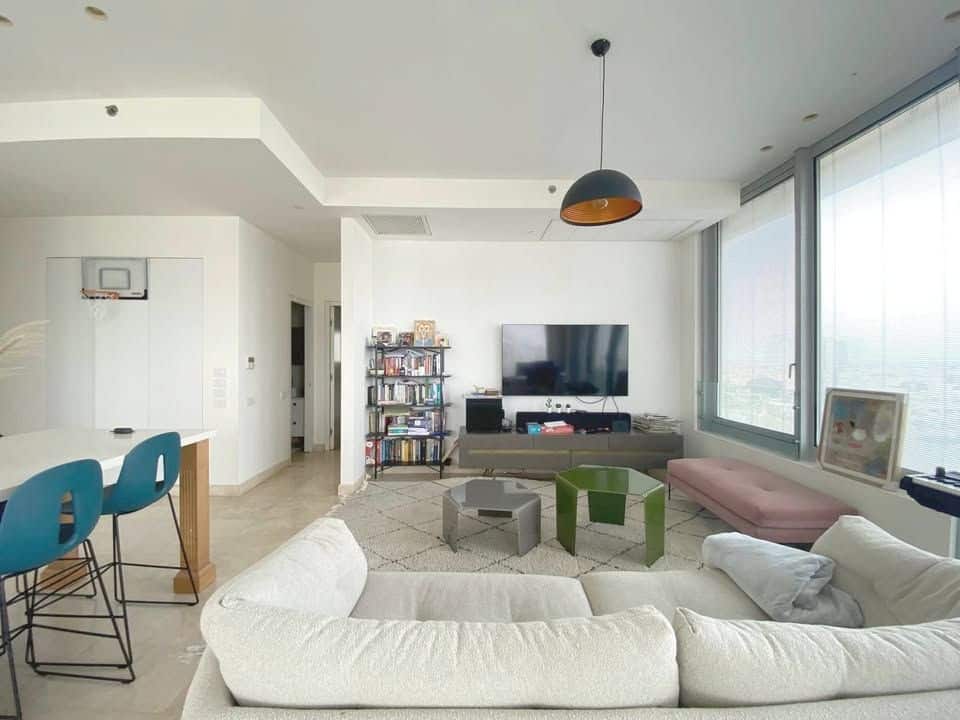 Spacious living room with large windows and city view