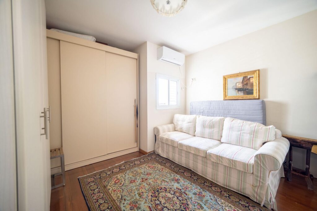 Cozy bedroom with natural light and large wardrobe