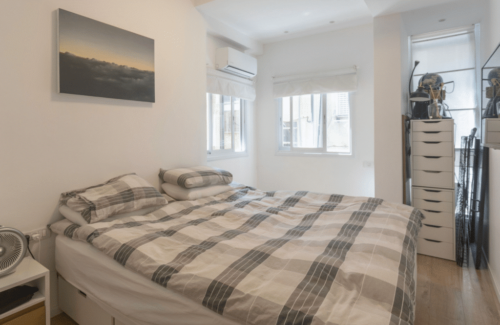 Bright master bedroom with large windows and minimalist design