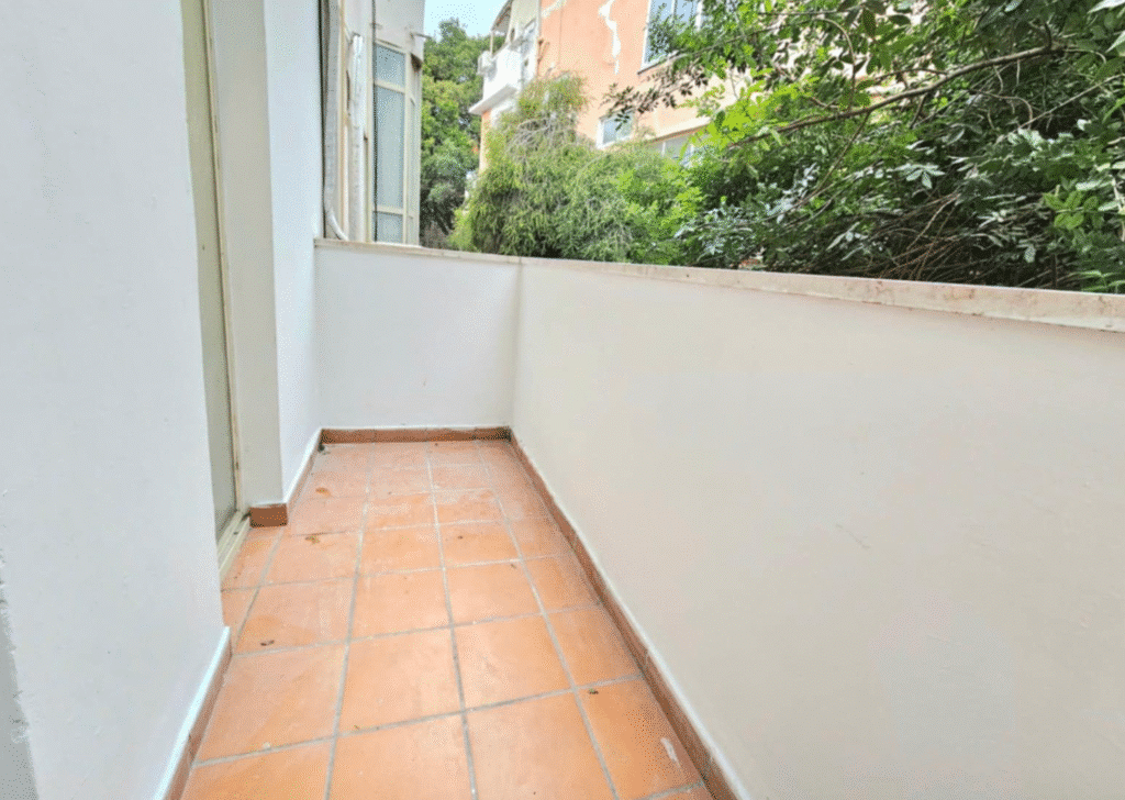 Private balcony with tile flooring and tree views