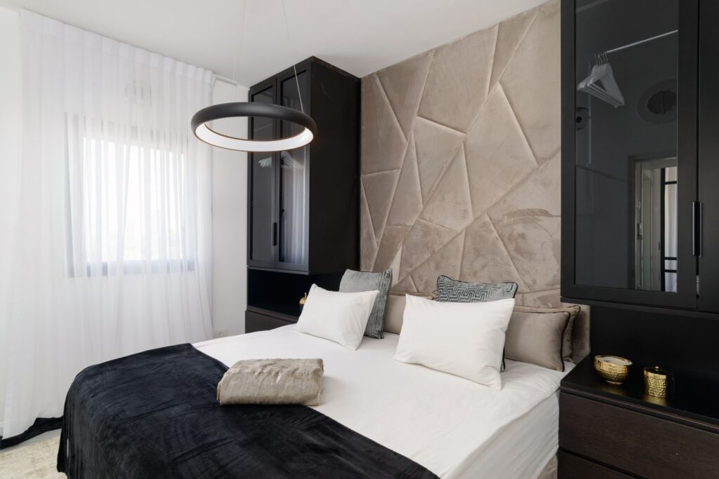 Stylish master bedroom with designer wall panel in Tel Aviv apartment