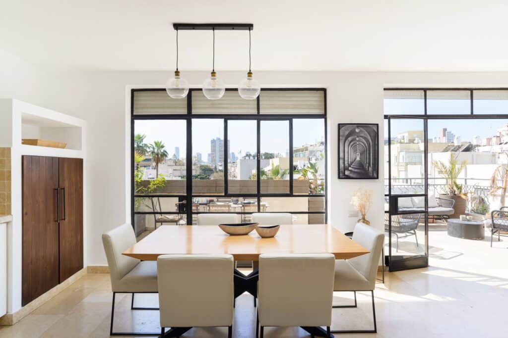 Bright dining room with large windows and city view