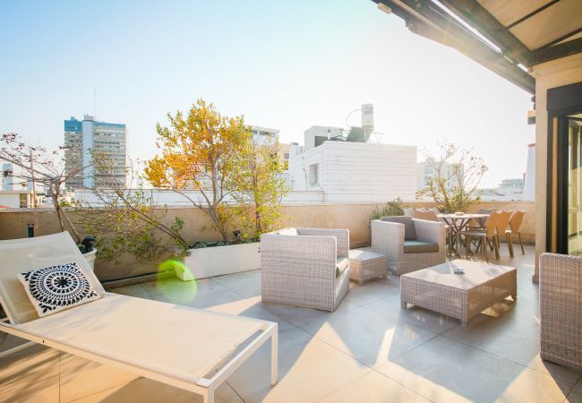 Sunny rooftop terrace with lounge furniture for short term stay