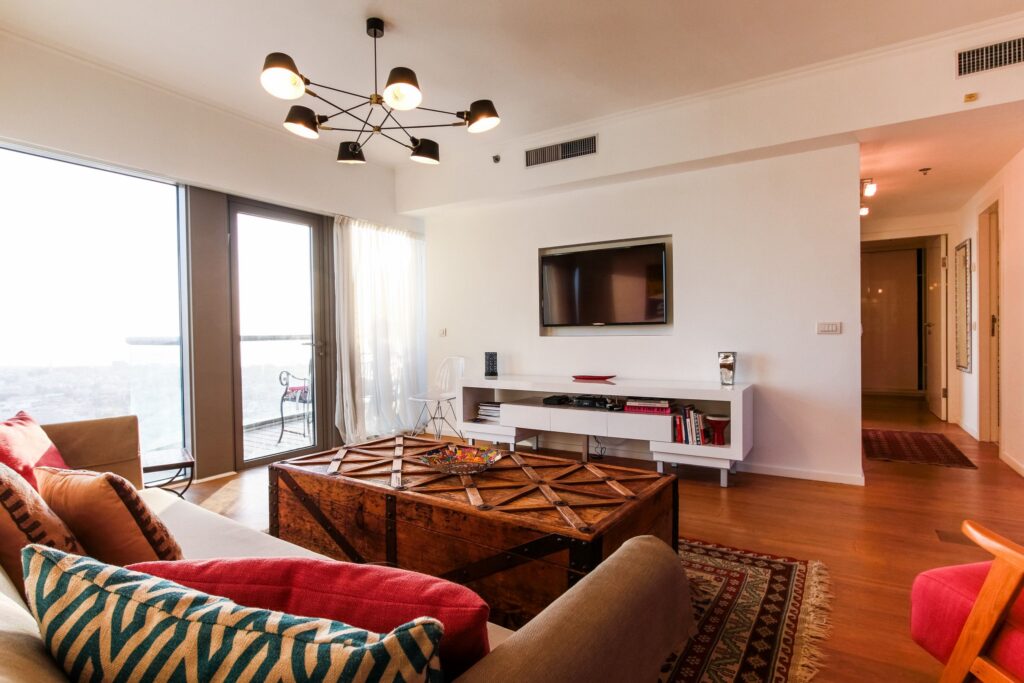Elegant living room with smart TV and vintage decor in Tel Aviv apartment
