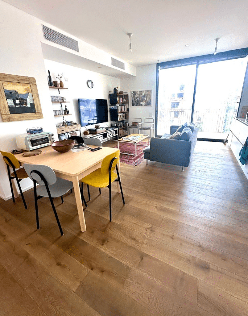 Open plan living and dining area with large windows