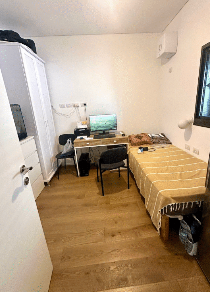 Bright bedroom with workspace and single bed