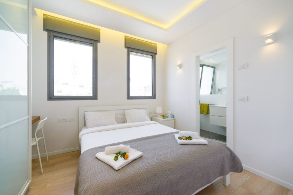 Minimalist bedroom with natural light and ensuite bathroom