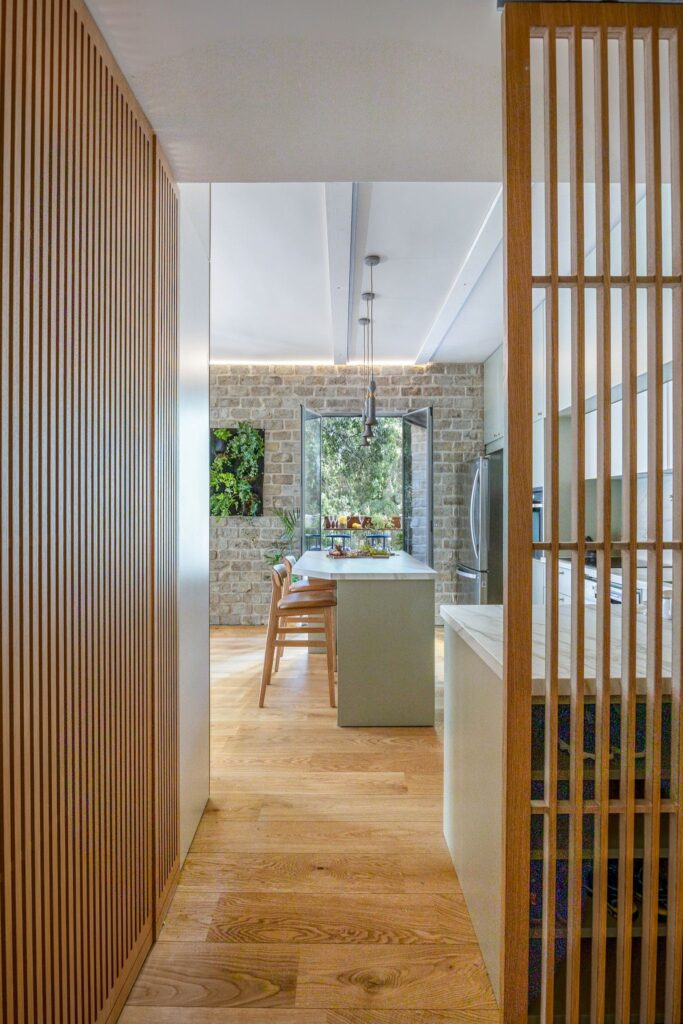 Kitchen island with fresh fruit and open view to balcony