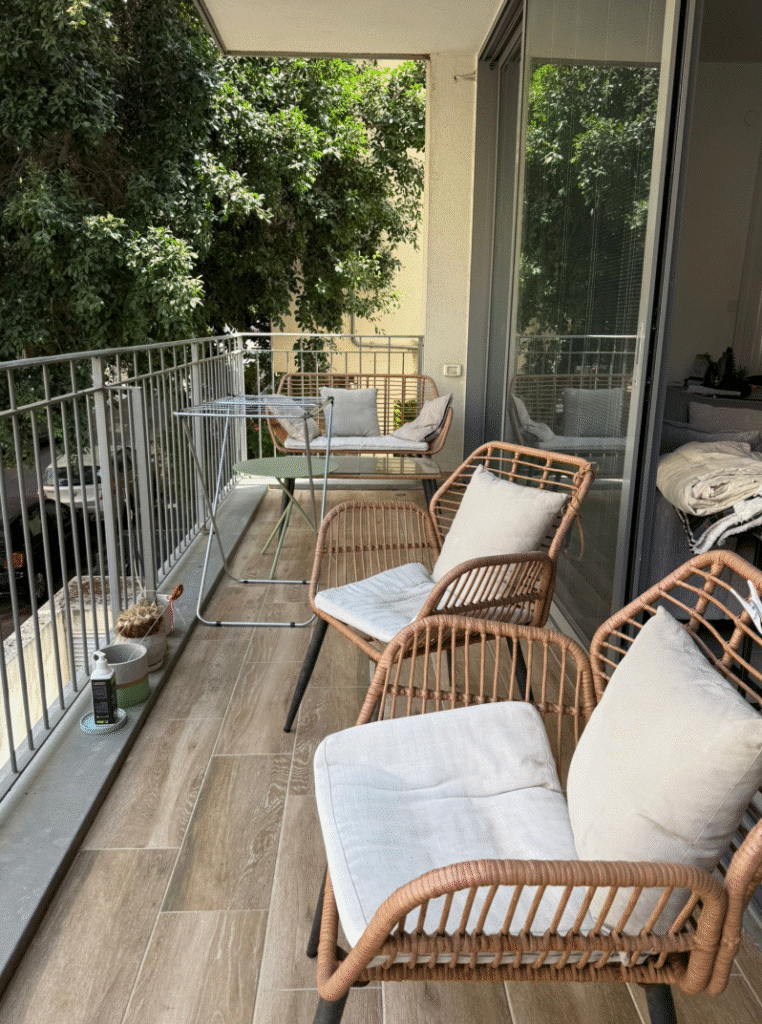 Sunny furnished balcony with garden view in Tel Aviv apartment