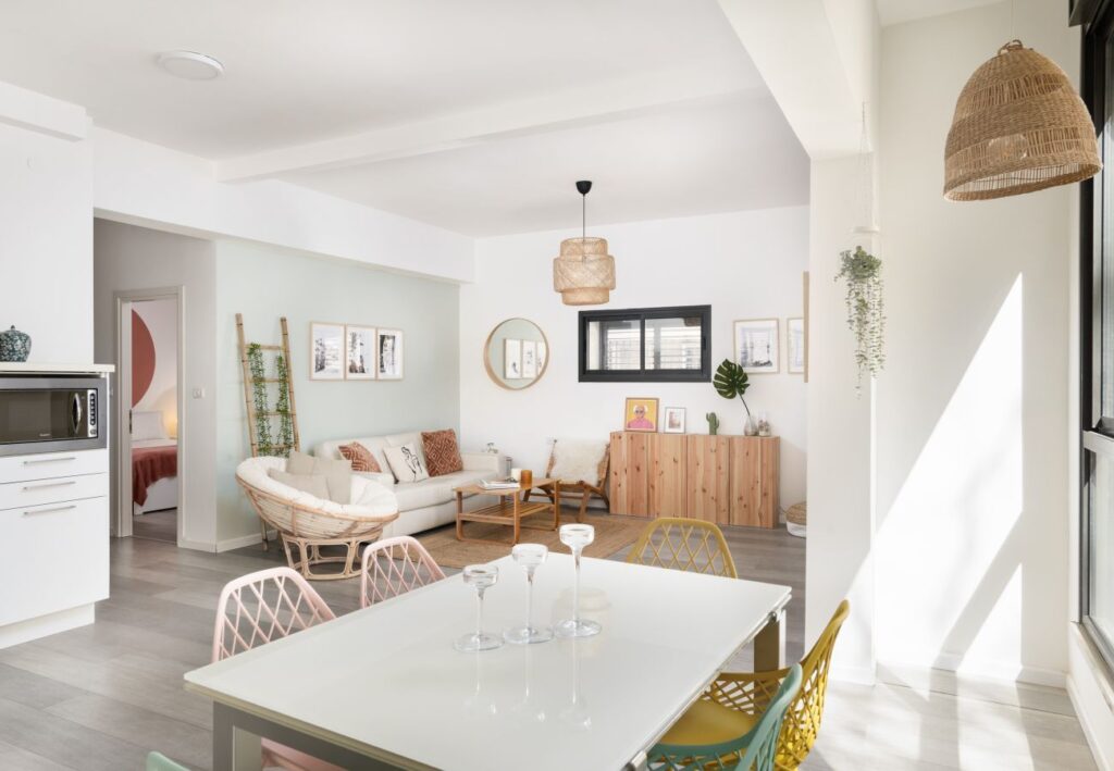 Sun-drenched dining area with colorful chairs near window