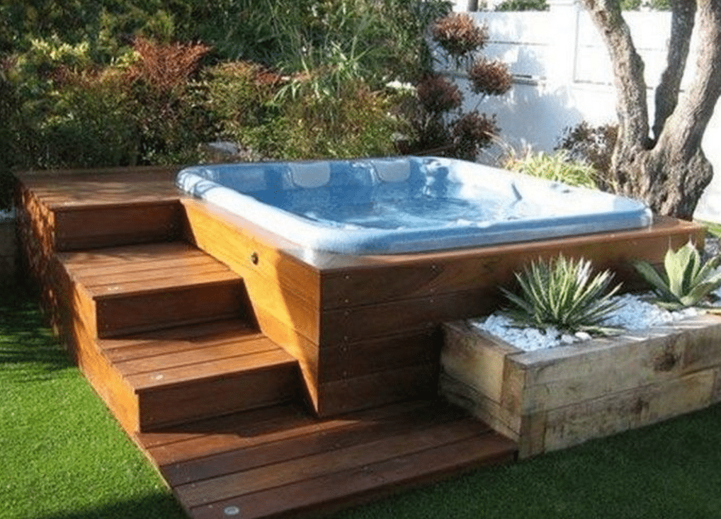 Outdoor jacuzzi with wood deck and garden landscape