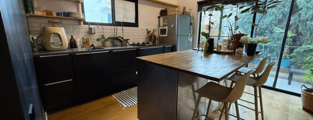 Stylish kitchen with island and floor-to-ceiling glass wall