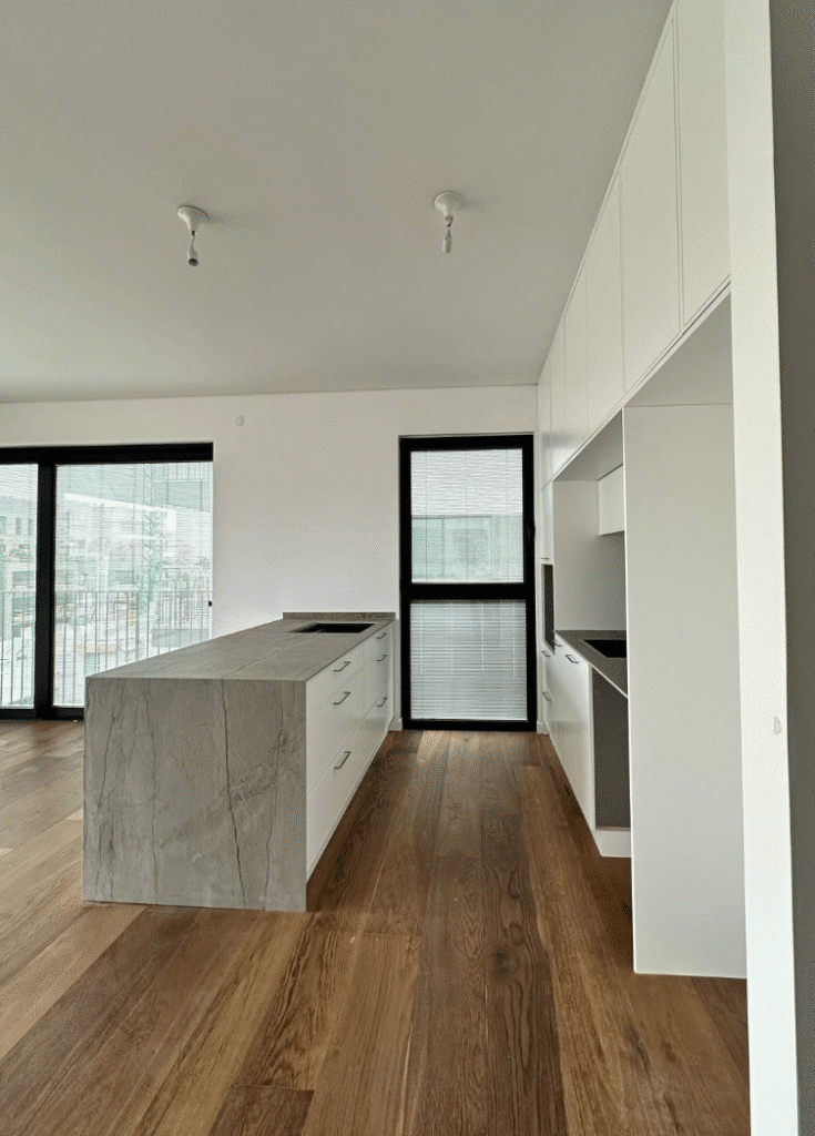 Modern kitchen island with stone finish in Tel Aviv apartment