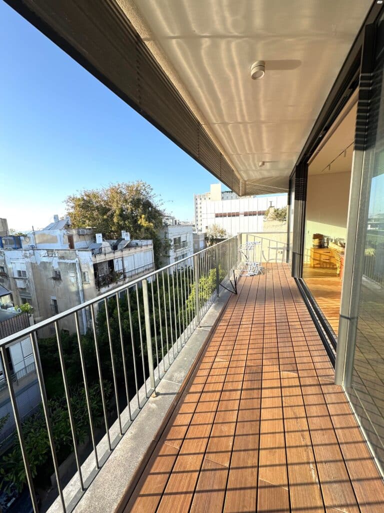 Spacious balcony overlooking green surroundings in Tel Aviv’s Old North