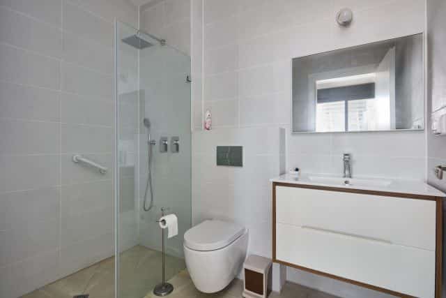 Modern bathroom with glass shower in Tel Aviv apartment