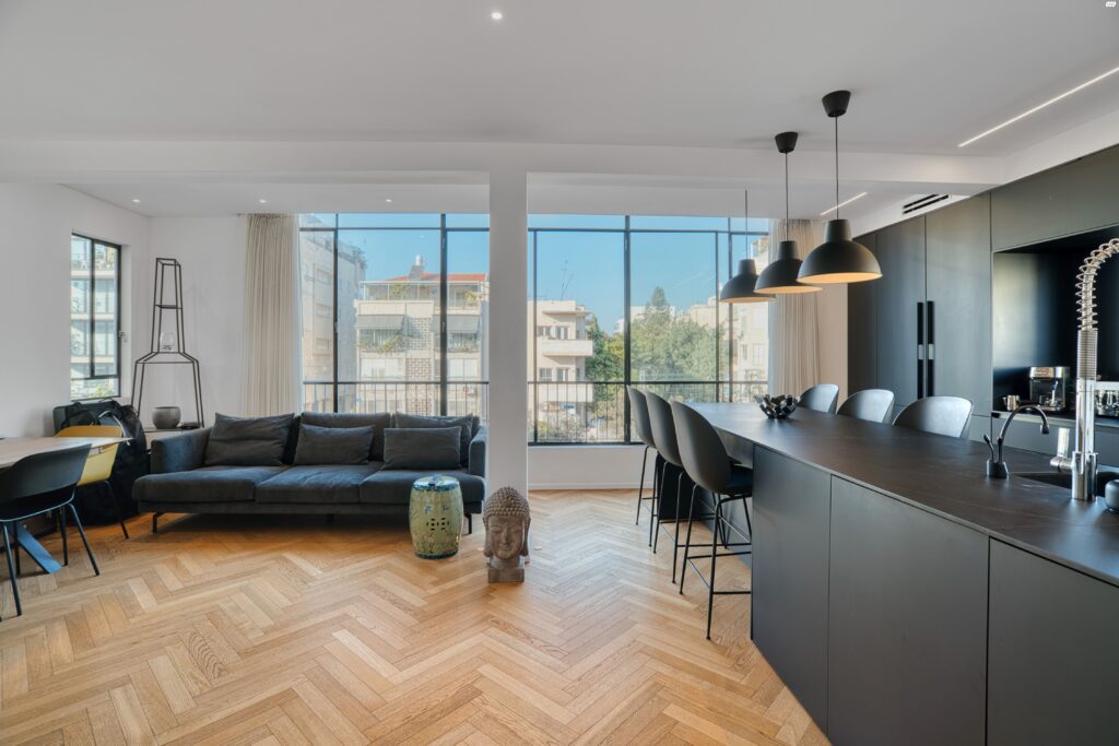 Bright living room with large windows and city views in Tel Aviv
