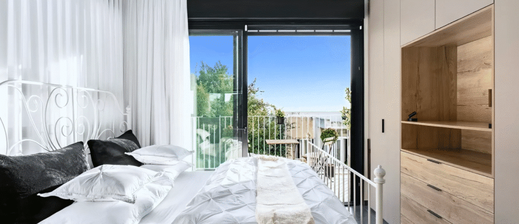 Bright bedroom with balcony in boutique rental apartment Tel Aviv