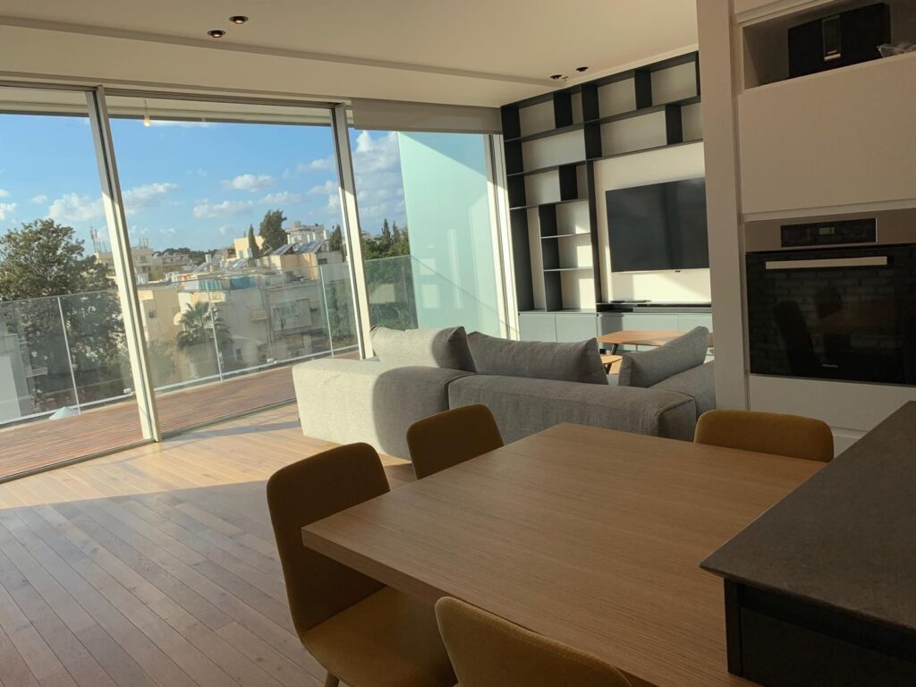 Modern living room and dining space in renovated Tel Aviv apartment
