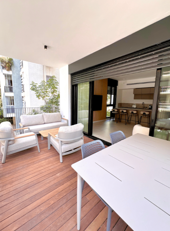 Spacious balcony with outdoor seating in boutique Tel Aviv apartment