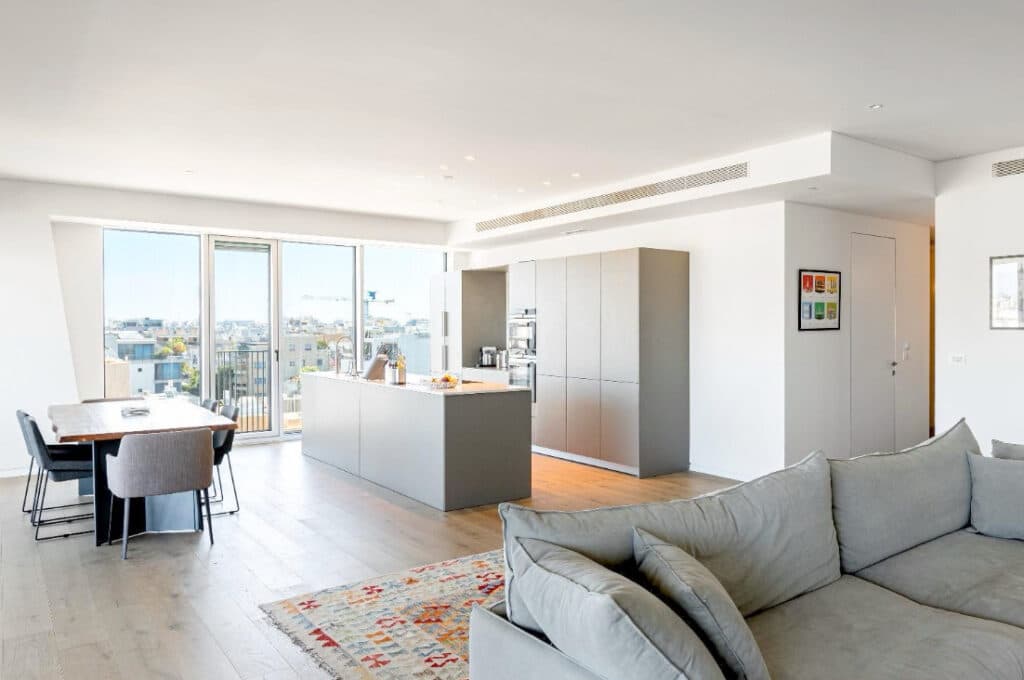 Sleek designer kitchen and dining area with panoramic windows in Tel Aviv apartment